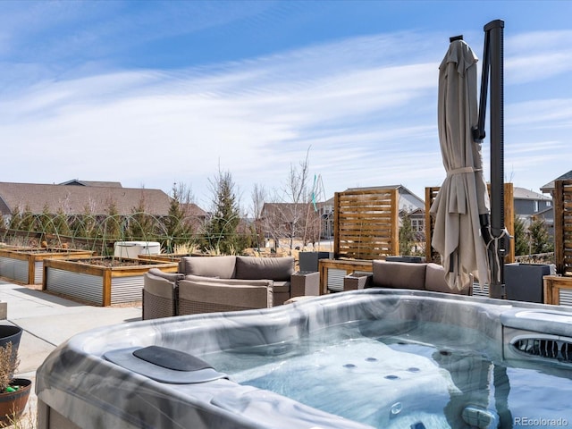 view of swimming pool with a garden and a hot tub