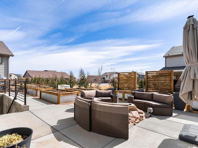 view of patio featuring an outdoor living space and a garden