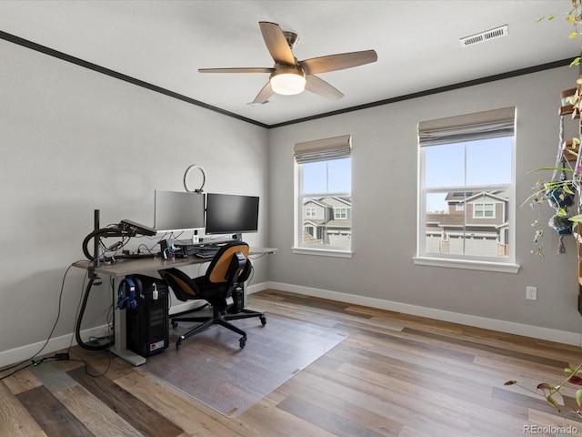 office with visible vents, wood finished floors, baseboards, and ornamental molding