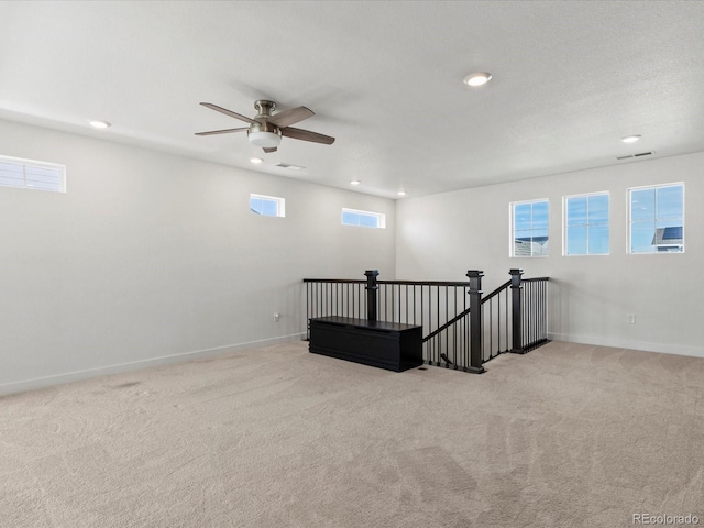 carpeted empty room with recessed lighting, visible vents, and baseboards