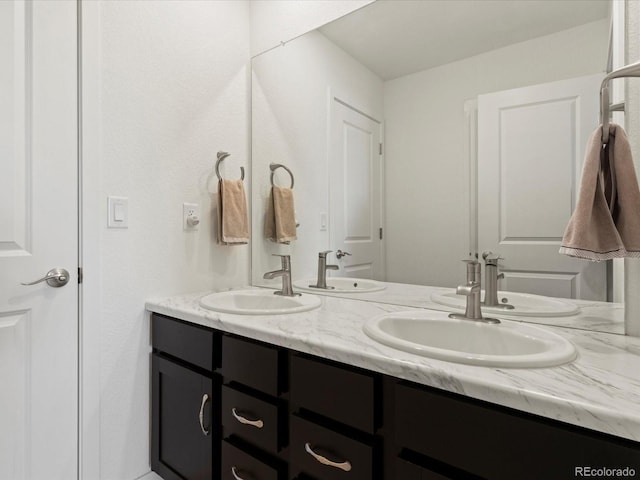 bathroom featuring a sink and double vanity