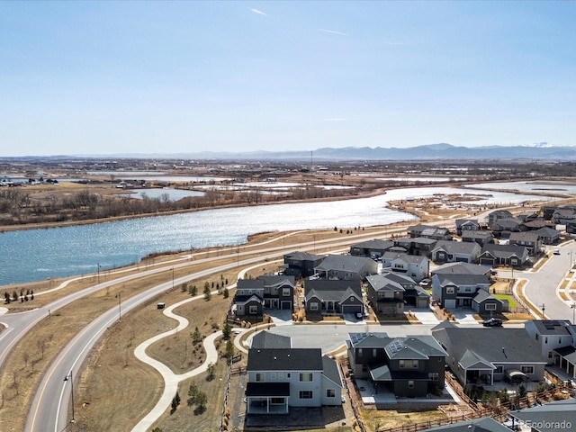 drone / aerial view with a residential view and a water and mountain view