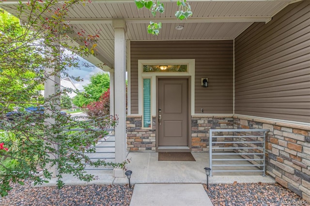 18112 E 104th Way, Commerce City, CO 80022 - doorway to property with covered porch and stone siding
