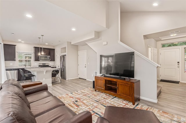 18112 E 104th Way, Commerce City, CO 80022 - living area featuring light wood-style flooring, stairs, baseboards, and recessed lighting