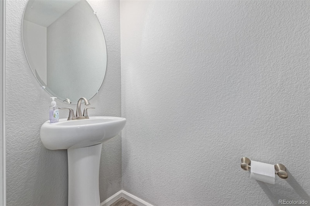 18112 E 104th Way, Commerce City, CO 80022 - bathroom with a textured wall and wood finished floors