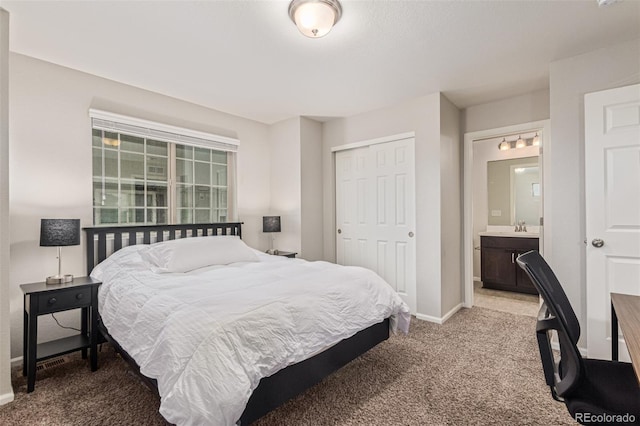 18112 E 104th Way, Commerce City, CO 80022 - bedroom with carpet, a closet, a sink, baseboards, and ensuite bath