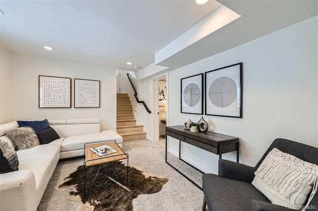 carpeted living area with stairway and recessed lighting