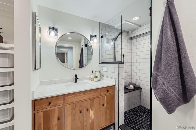 full bathroom featuring walk in shower and vanity