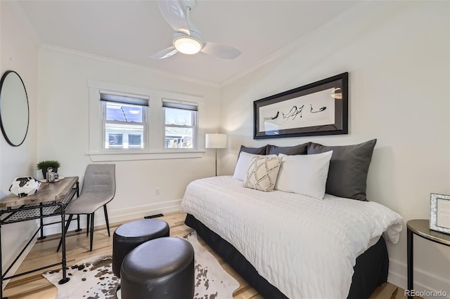 bedroom with ornamental molding, wood finished floors, a ceiling fan, and baseboards