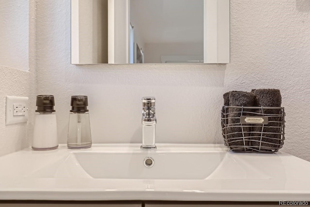 details with a textured wall and a sink