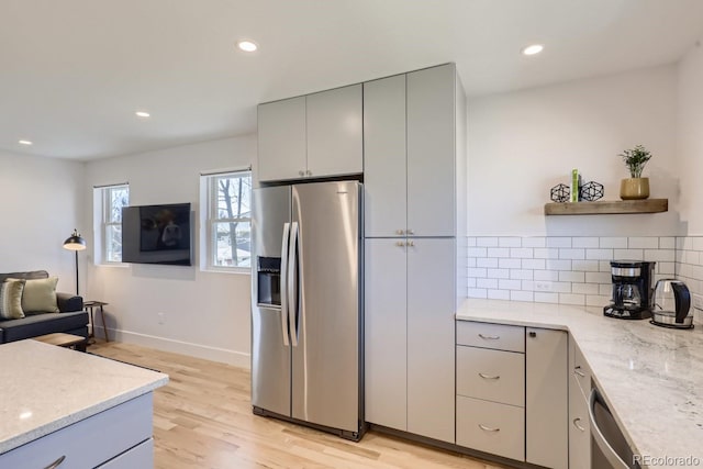 kitchen with stainless steel appliances, light wood-style floors, gray cabinetry, and open shelves