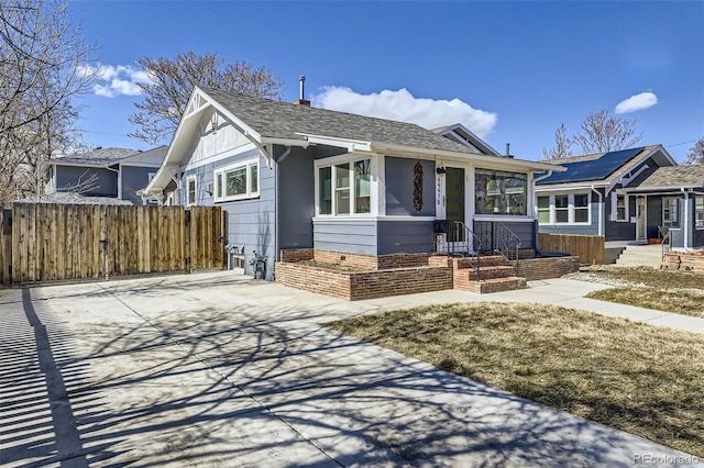 4441 N Meade St, Denver, CO 80211 - view of front of house featuring roof with shingles, fence, and a chimney