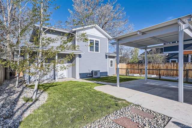 4441 N Meade St, Denver, CO 80211 - view of side of property featuring a lawn, a patio, ac unit, and a fenced backyard