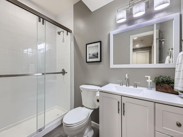 15269 W 69th Cir Unit A, Arvada, CO 80007 - bathroom featuring vanity, a stall shower, and a textured wall