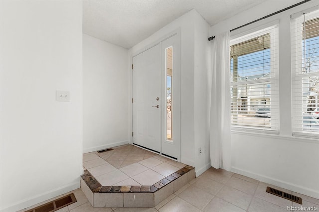 foyer with light tile patterned floors