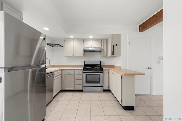 kitchen featuring sink, beamed ceiling, light tile patterned flooring, and appliances with stainless steel finishes