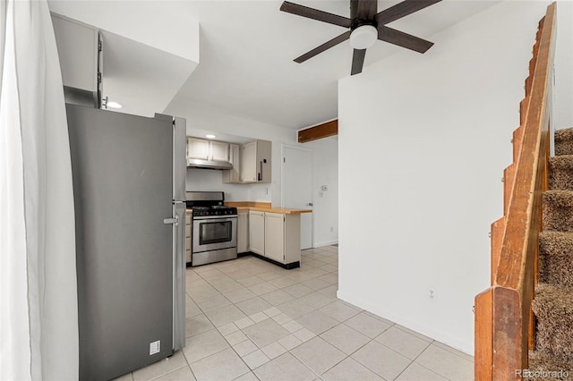 kitchen with white cabinets, beam ceiling, stainless steel appliances, and ceiling fan