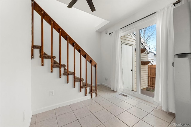 tiled entrance foyer featuring ceiling fan