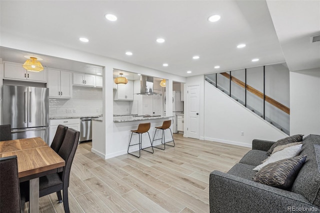 7995 E Mississippi Ave Unit A4, Denver, CO 80247 - living area with light wood-style flooring, stairs, recessed lighting, and baseboards