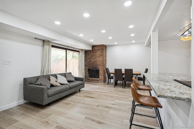 7995 E Mississippi Ave Unit A4, Denver, CO 80247 - living area featuring recessed lighting, light wood-type flooring, a fireplace, and baseboards