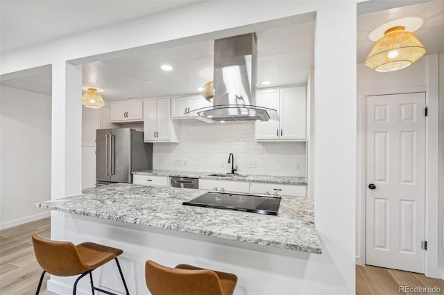 7995 E Mississippi Ave Unit A4, Denver, CO 80247 - kitchen featuring island range hood, appliances with stainless steel finishes, a sink, a kitchen breakfast bar, and white cabinetry