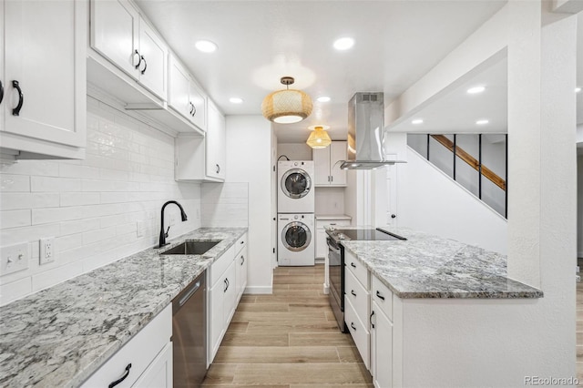 7995 E Mississippi Ave Unit A4, Denver, CO 80247 - kitchen featuring island range hood, stacked washing machine and dryer, a sink, stainless steel appliances, and recessed lighting