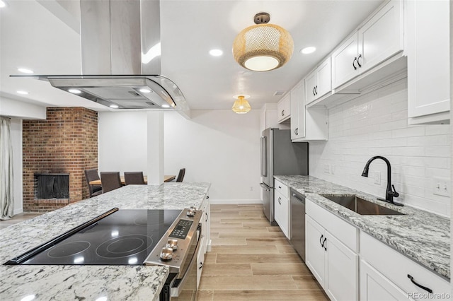 7995 E Mississippi Ave Unit A4, Denver, CO 80247 - kitchen featuring a sink, appliances with stainless steel finishes, island exhaust hood, tasteful backsplash, and white cabinets