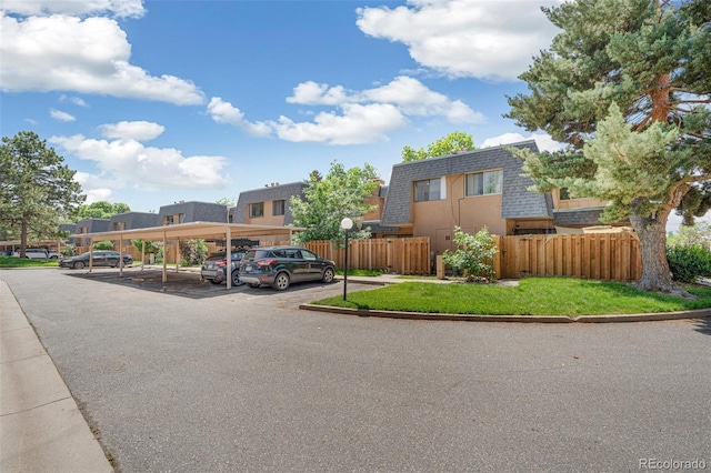 7995 E Mississippi Ave Unit A4, Denver, CO 80247 - view of front of home featuring covered parking, mansard roof, a shingled roof, and a residential view