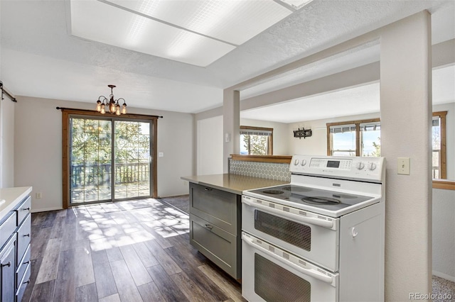 255 Park View Dr, Fairplay, CO 80440 - kitchen with double oven range, light countertops, gray cabinetry, an inviting chandelier, and dark wood-type flooring