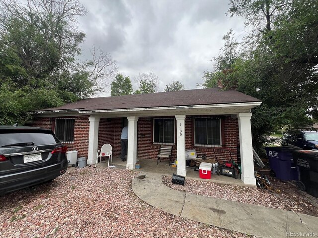 1900 Quebec St, Denver, CO 80220 - view of front of home featuring brick siding and a shingled roof
