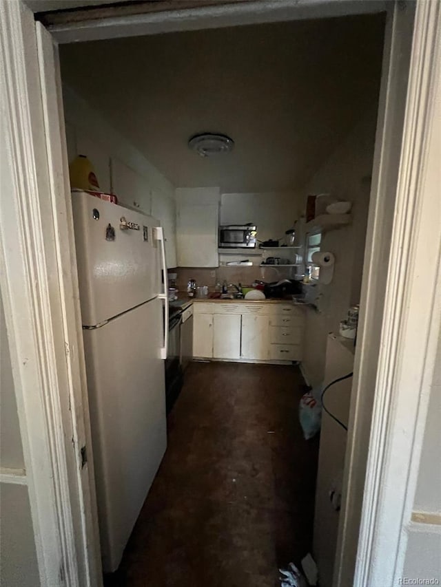 1900 Quebec St, Denver, CO 80220 - kitchen featuring freestanding refrigerator, stainless steel microwave, white cabinets, a sink, and light countertops