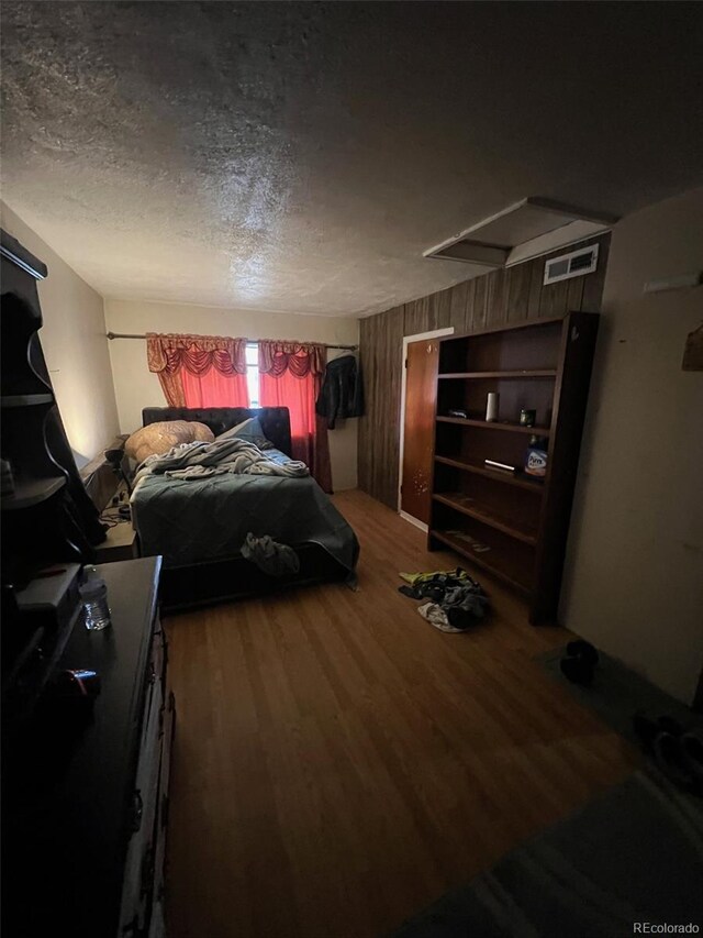 1900 Quebec St, Denver, CO 80220 - bedroom featuring wood finished floors and a textured ceiling