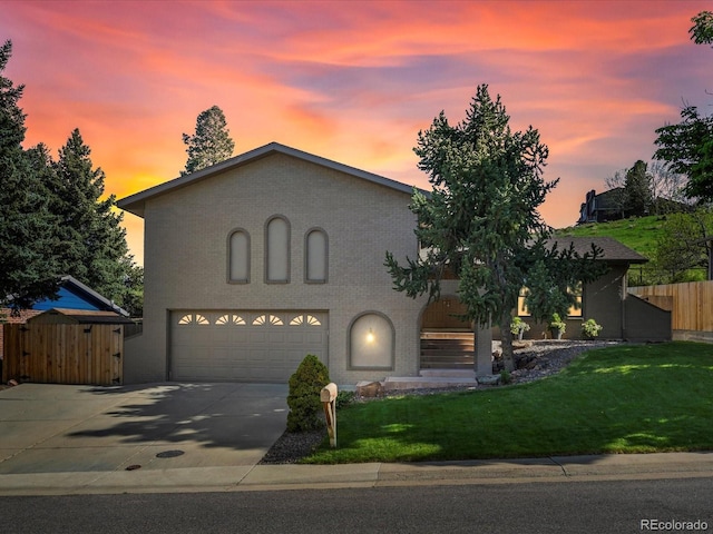 14418 W Bayaud Ave, Golden, CO 80401 - view of front of home with a garage, concrete driveway, and brick siding