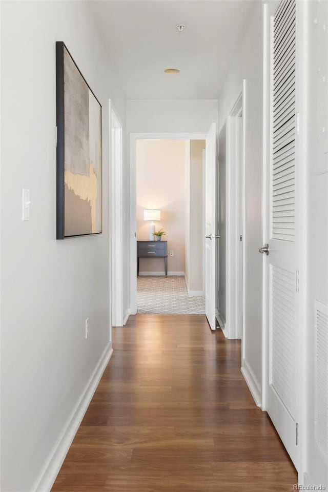 hallway with dark wood-type flooring