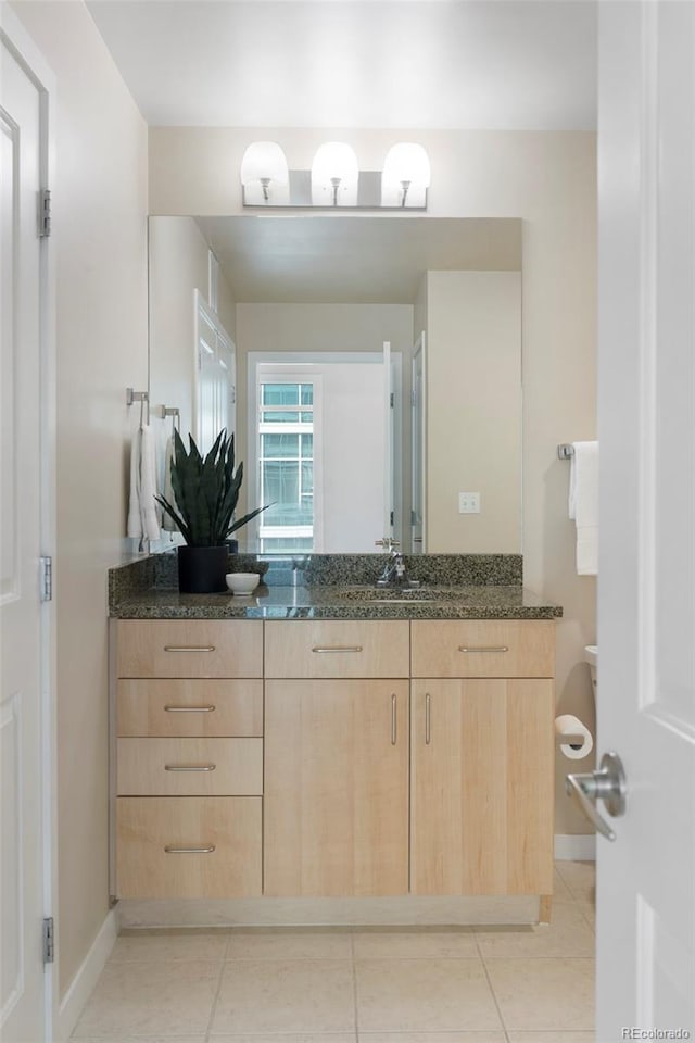 bathroom with tile patterned flooring and vanity