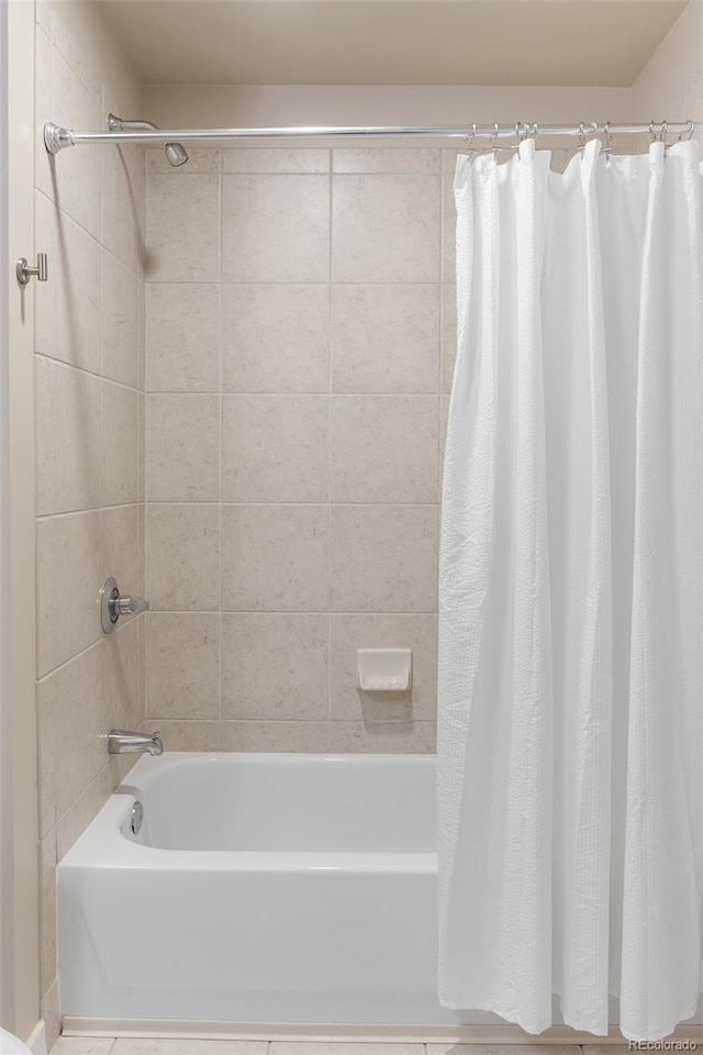 bathroom with shower / bath combo with shower curtain