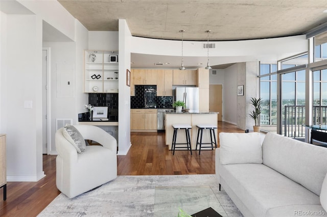 living room with floor to ceiling windows and wood-type flooring