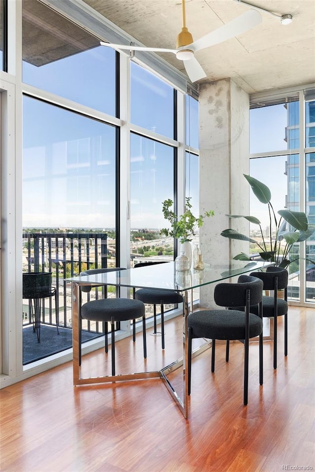 dining room featuring hardwood / wood-style floors and a wall of windows