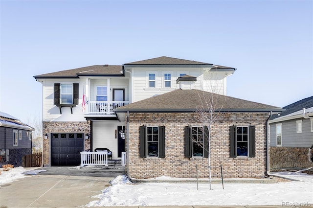 view of front facade featuring a garage and a balcony