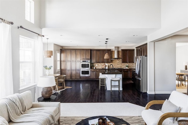 living room featuring sink and dark hardwood / wood-style floors