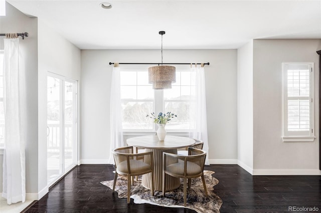 dining area featuring dark wood-type flooring and a wealth of natural light