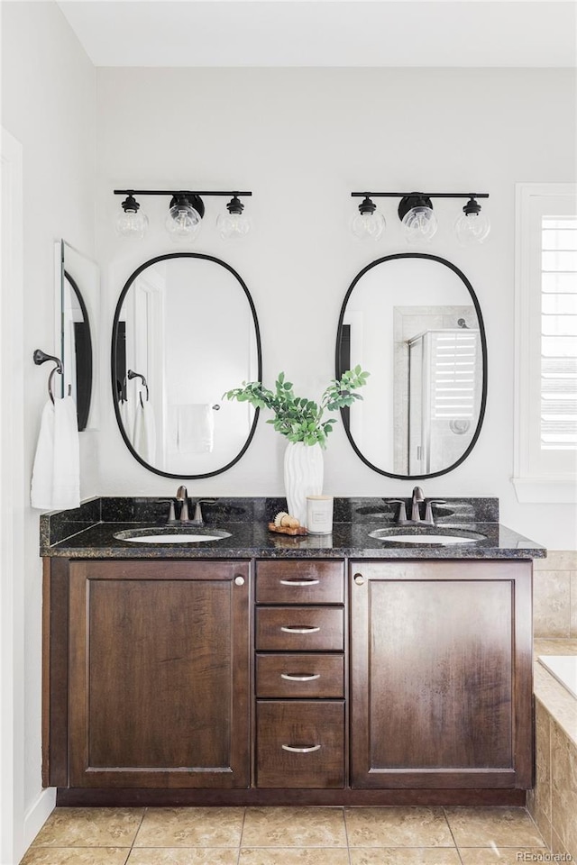 bathroom featuring vanity, plus walk in shower, and tile patterned flooring