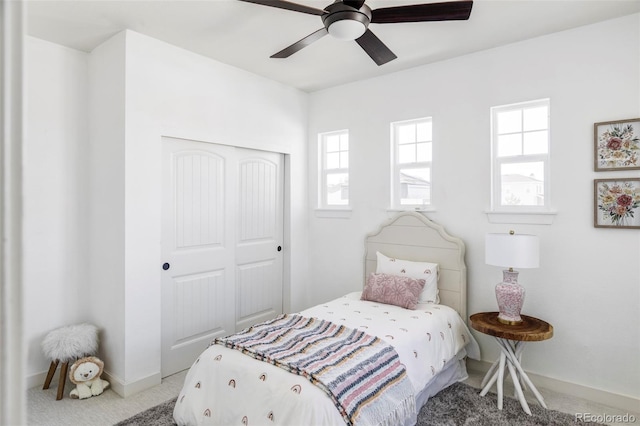 bedroom featuring carpet flooring, ceiling fan, and a closet