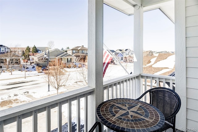 view of snow covered back of property