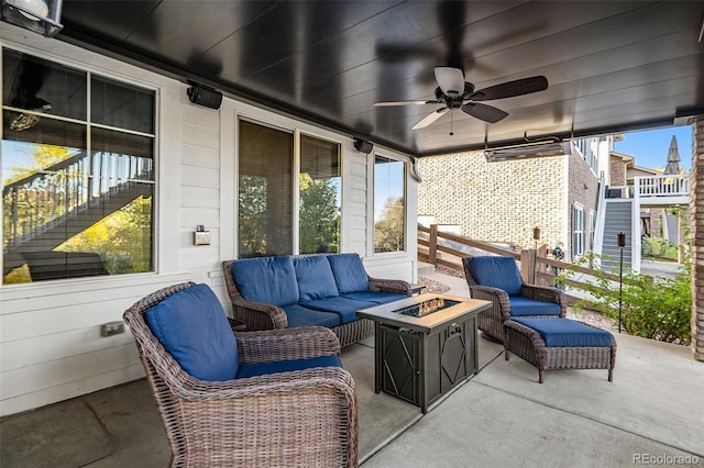 view of patio / terrace with an outdoor living space with a fire pit and ceiling fan