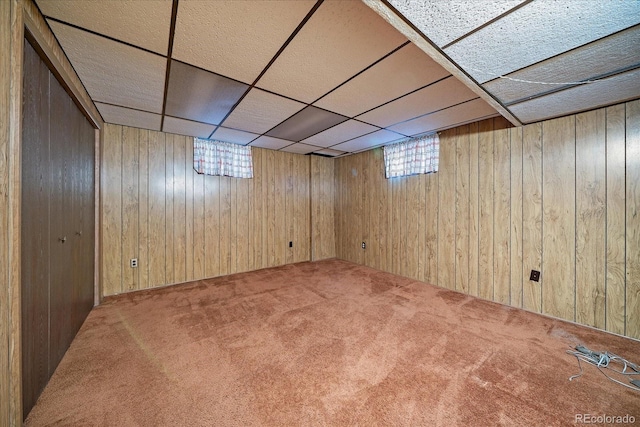 7077 Dudley Dr, Arvada, CO 80004 - basement featuring carpet floors, wooden walls, and a paneled ceiling
