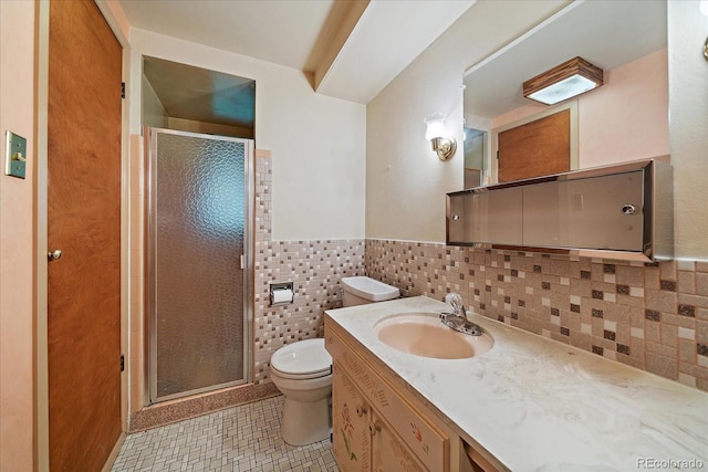 7077 Dudley Dr, Arvada, CO 80004 - full bathroom featuring vanity, a stall shower, tile patterned flooring, a wainscoted wall, and tile walls