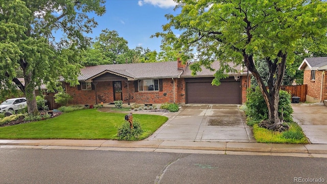 7077 Dudley Dr, Arvada, CO 80004 - single story home featuring an attached garage, brick siding, concrete driveway, and a chimney