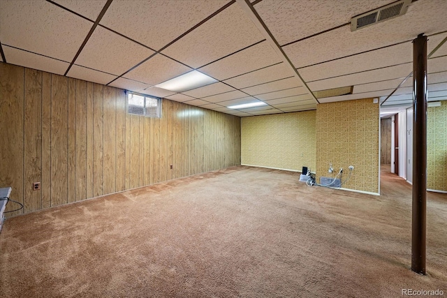 7077 Dudley Dr, Arvada, CO 80004 - basement featuring carpet, wood walls, and a paneled ceiling