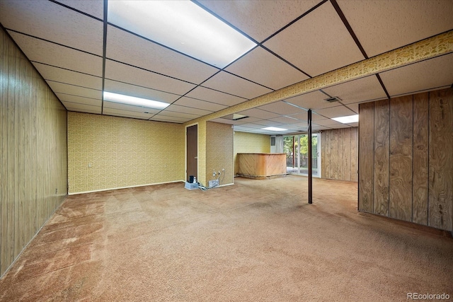 7077 Dudley Dr, Arvada, CO 80004 - below grade area featuring a paneled ceiling, wooden walls, and carpet flooring